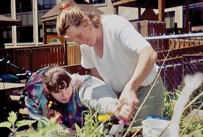 Teacher and student gardening